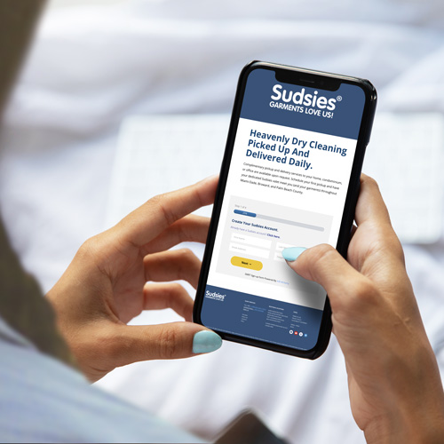 Guest views Sudsies dry cleaning sign-up screen on smartphone