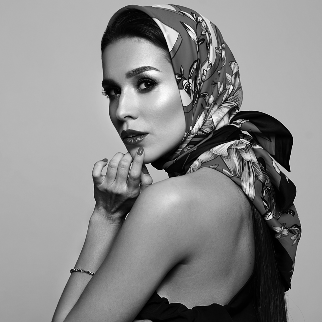 Woman wearing a patterned silk scarf styled around the head